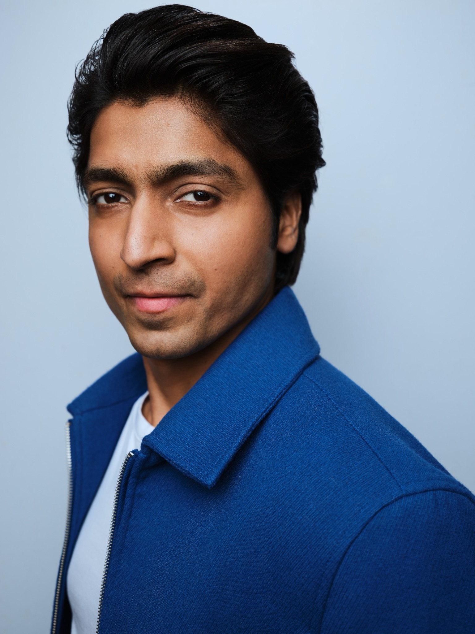 Harsh Kumar Shakti polished dramatic headshot in blue